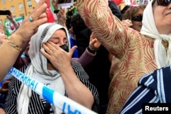 People react to the verdict of the trial of Hamid Nouri, a former Iranian official accused of crimes against international law and murder in Iran in 1988, outside the Stockholm District Court on July 14, 2022. (Chris Anderson/TT News Agency/via Reuters)