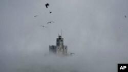Steam rises off of Lake Michigan as temperatures were below zero with heavy winds in Milwaukee. Winter weather is blanketing the U.S. as a massive storm sent temperatures crashing and created whiteout conditions.