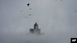 FILE: Steam rises off of Lake Michigan as morning temperatures remain below zero with heavy winds Friday, Dec. 23, 2022, in Milwaukee, U.S.