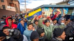 Migrants, mostly from Venezuela, chant slogans as an activists' march in their support arrives to downtown El Paso, Texas, Jan. 7, 2023.