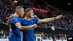 FILE - PSG's Kylian Mbappe, left, celebrates with teammate PSG's Achraf Hakimi at the Francis-Le Ble stadium in Brest, France, Aug. 20, 2021. Wednesday, Mbappe, playing for France, and Hakimi, playing for Morocco, face off in a World Cup match.