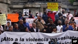 FILE - Journalists protest to draw attention to journalist killings,at the Angel of Independence monument in Mexico City, May 9, 2022. Mexico remains one of the most dangerous countries for journalists.