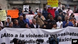 FILE - Journalists protest to draw attention to journalist killings in Mexico City, May 9, 2022. A journalist was shot dead Tuesday in western Mexico.