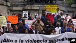 FILE - Journalists protest to draw attention to journalist killings,at the Angel of Independence monument in Mexico City, May 9, 2022. Mexico remains one of the most dangerous countries for journalists. 