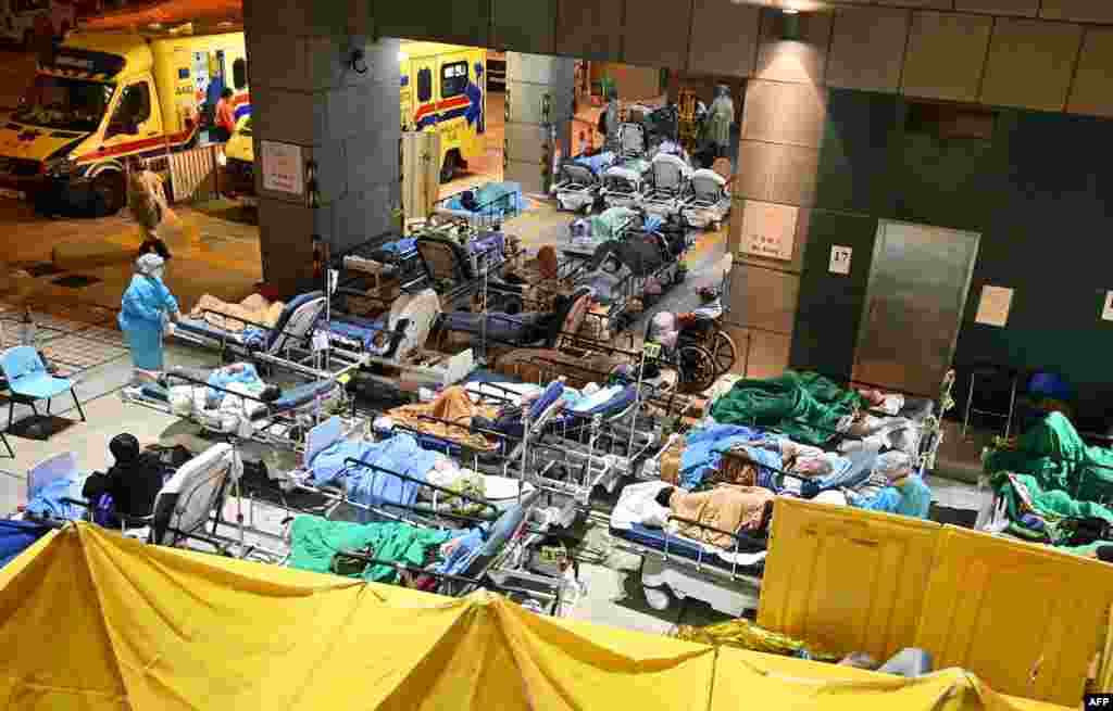 People lie in hospital beds with temperatures falling at nighttime outside the Caritas Medical Centre in Hong Kong, Feb. 16, 2022, as hospitals become overwhelmed with the city facing its worst Covid-19 coronavirus wave to date. 