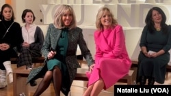 U.S. first lady Jill Biden, center right, and visiting French first lady Brigitte Macron, center left, take questions from students at Planet Word Museum in Washington on Dec. 1, 2022. 