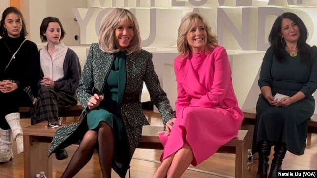 U.S. first lady Jill Biden, center right, and visiting French first lady Brigitte Macron, center left, take questions from students at Planet Word Museum in Washington on Dec. 1, 2022.