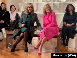FILE - US first lady Jill Biden, center right, and visiting French first lady Brigitte Macron, center left, take questions from students at Planet Word Museum in Washington, Dec. 1, 2022. (Photo by Natalie Liu)
