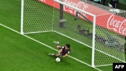 Morocco's goalkeeper Yassine Bounou deflects a penalty kick by Spanish midfielder Carlos Soler during the penalty shootout of their knockout round of 16 2022 FIFA World Cup clash at the Education City Stadium in Al-Rayyan, west of Doha on Dec. 6, 2022.