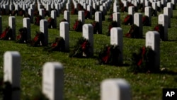 FILE - Headstones adorned with wreaths are seen at Arlington National Cemetery, Dec. 17, 2022, in Arlington, Va.