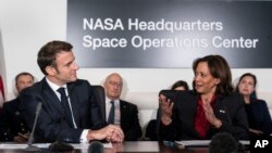 French President Emmanuel Macron, left, and Vice President Kamala Harris meet at NASA headquarters in Washington, Nov. 30, 2022.