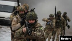 Ukrainian servicemen participate in joint drills of by the armed forces, national guard and Security Service of Ukraine (SBU) near the border with Belarus, amid Russia's attacks on its neighbor, in Rivne region, Ukraine, Jan. 11, 2023.