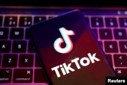 ILUSTRACIJA - Logo TikToka na ekranu mobilnog telefona ispred tastature (Foto: Reuters/Dado Ruvić)