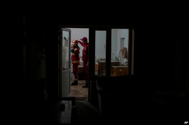 Paramedics get ready at the ambulance station in Kherson, southern Ukraine, Sunday, Nov. 20, 2022. (AP Photo/Roman Hrytsyna)