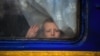 A child looks through the window of an evacuation train in the Donetsk region on Nov. 30, 2022, during the Russian invasion of Ukraine.