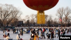 People enjoy an ice rink on a frozen lake, amid the coronavirus disease (COVID-19) outbreak in Beijing, China December 31, 2022. REUTERS/Florence Lo