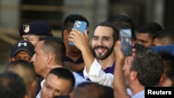 FILE - El Salvador's President Nayib Bukele smiles while someone takes a picture of him during an event, in Nahuizalco, El Salvador, Sept. 7, 2022.