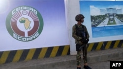 A Nigerian soldier stands outside the new construction site of the headquarters of the Economic Community of West African States (ECOWAS) during the 62nd Ordinary Session of ECOWAS Authority of Heads of State and Government in Abuja, Dec. 4, 2022. 