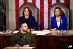 Ukrainian President Volodymyr Zelenskyy looks to the guests of the Ukrainian delegation as he addresses a joint meeting of Congress on Capitol Hill in Washington, D.C., on December 21, 2022. (Carolyn Kaster/AP)