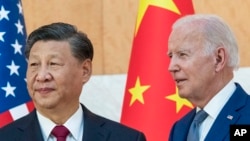 FILE - U.S. President Joe Biden stands with Chinese President Xi Jinping before a meeting on the sidelines of the G20 summit meeting, in Bali, Indonesia, Nov. 14, 2022. The two will meet Nov. 15, 2023, in California.