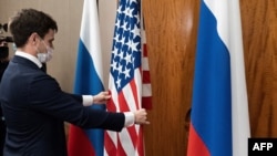 FILE - U.S. and Russian flags are adjusted ahead of a high-level bilateral meeting in Geneva, Switzerland, Jan. 21, 2022. Russia on Monday postponed nuclear weapons talks with the U.S. which were to take place this week in Cairo, Egypt.