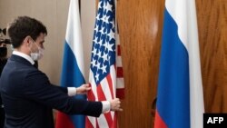 FILE - U.S. and Russian flags adjusted before a high-level bilateral meeting in Geneva, Switzerland, Jan. 21, 2022. Russia on Monday postponed nuclear weapons talks with the U.S. which were to take place this week in Cairo, Egypt.