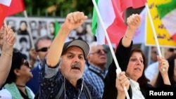 People react to the verdict of the trial of Hamid Nouri, a former Iranian official accused of crimes against international law and murder in Iran in 1988, outside the Stockholm District Court on July 14, 2022. (Chris Anderson/TT News Agency/via Reuters)
