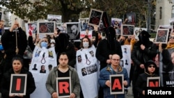 FILE - People take part in a protest against the Islamic regime of Iran following the death of Mahsa Amini, in Istanbul, Turkey, Dec. 10, 2022.