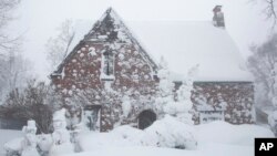 A winter storm rolls through western New York, Dec. 24, 2022, in Amherst, NY. 