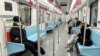 FILE - Commuters wear protective masks while they ride a subway in Shanghai, China, Dec. 20, 2022.