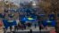 FILE - Kosovo's flags fly in Pristina as police officers patrol during a celebration of the country's independence, Feb. 17, 2020.