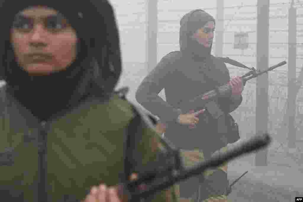 Border Security Force personnel patrol along the border fence during a cold, foggy morning near India-Pakistan Wagah border, about 40 km from Amritsar.