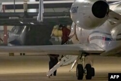 WNBA star Brittney Griner exits a plane in San Antonio, Texas, after she was released from a Russian prison in exchange for an arms dealer.