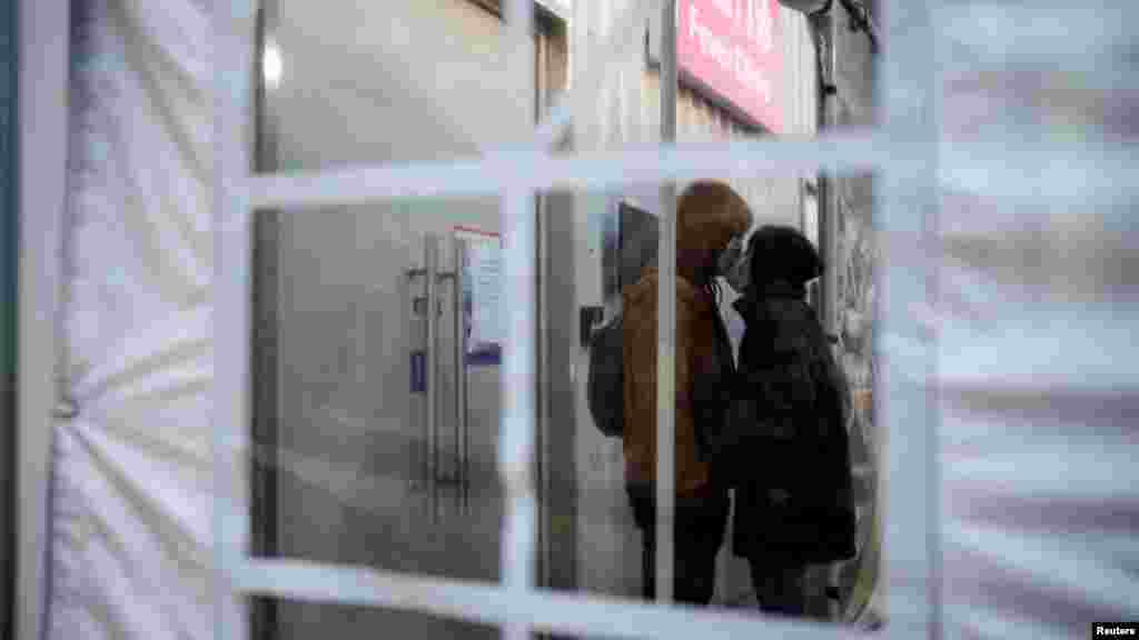 A couple wearing protective masks kiss at a hospital&#39;s fever clinic as COVID-19 outbreaks continue in Shanghai. REUTERS/Aly Song&nbsp;&nbsp;