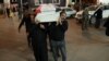 Mourners carry the coffin of a policeman killed in an attack in Kirkuk, during his funeral in Najaf, Iraq, Dec. 18, 2022.