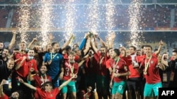 FILE: The Morocco team celebrates after winning the African Nations Championship (CHAN) final football match between Morocco and Mali at Stade Ahmadou Ahidjo in Yaounde, Cameroon, on February 7, 2021