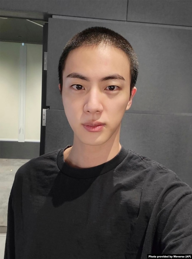 Jin of K-pop band BTS shows off freshly shaved hair on the K-pop social media platform Weverse, which was uploaded Dec. 11, 2022, ahead of his upcoming military conscription. (Weverse via AP)