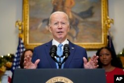 President Joe Biden speaks in the Roosevelt Room of the White House, Thursday, Dec. 8, 2022, in Washington. With the President from left, Vice President Kamala Harris and Cherelle Griner, Brittney Griner's wife.