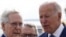 U.S. President Joe Biden is greeted by Senate Republican Leader Mitch McConnell (R-KY) and Ohio Governor Mike DeWine as he arrives at Cincinnati Northern Kentucky Airport in Hebron, Kentucky, U.S., January 4, 2023.