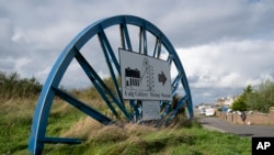 FILE - A "closed" sign is seen outside the Haig Colliery Mining Museum close to the site of a proposed new coal mine near the Cumbrian town of Whitehaven in northwest England, Oct. 4, 2021.