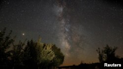 FILE - The Milky Way is seen during the Perseids meteor shower in Berducedo, Spain, Aug. 12, 2018.