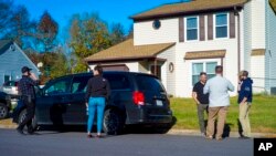 FBI agents gather outside the home of Andre Bing, Nov. 23, 2022, in Chesapeake, Va. Bing, a Walmart manager, opened fire on fellow employees the night before in a break room of a Virginia store.