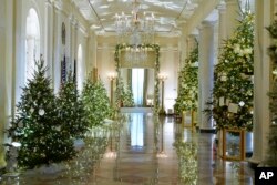 Cross Hall of the White House is decorated for the holiday season during a press preview of holiday decorations at the White House, Nov. 28, 2022, in Washington.
