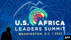 A man bypasses the logo of the U.S.-Africa Leaders Summit in Washington D.C., Dec 13, 2022.