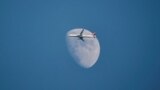 A Turkish Airlines Airbus A321-231 aircraft flies past the moon as it descends for Istanbul Airport in Istanbul, Turkey, Jan. 1, 2023.