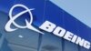 FILE - Signage for Boeing is seen on a trade pavilion, July 19, 2022. 