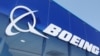 FILE - Signage for Boeing is seen on a trade pavilion, July 19, 2022. 