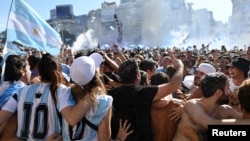 Fans celebrate their team's win at the World Cup, in central Buenos Aires, Argentina, Dec. 18, 2022.