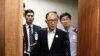 FILE - Former South Korean President Lee Myung-bak, center, appears for his first trial at the Seoul Central District Court in Seoul, May 23, 2018. Lee, who was sentenced to a 17-year prison term for a range of corruption crimes, received a presidential pardon, Dec. 27, 2022.