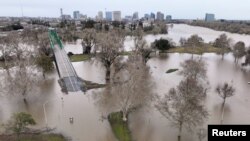 A view of flooding from the rainstorm-swollen Sacramento and American Rivers, near downtown Sacramento, California, Jan. 11, 2023. 